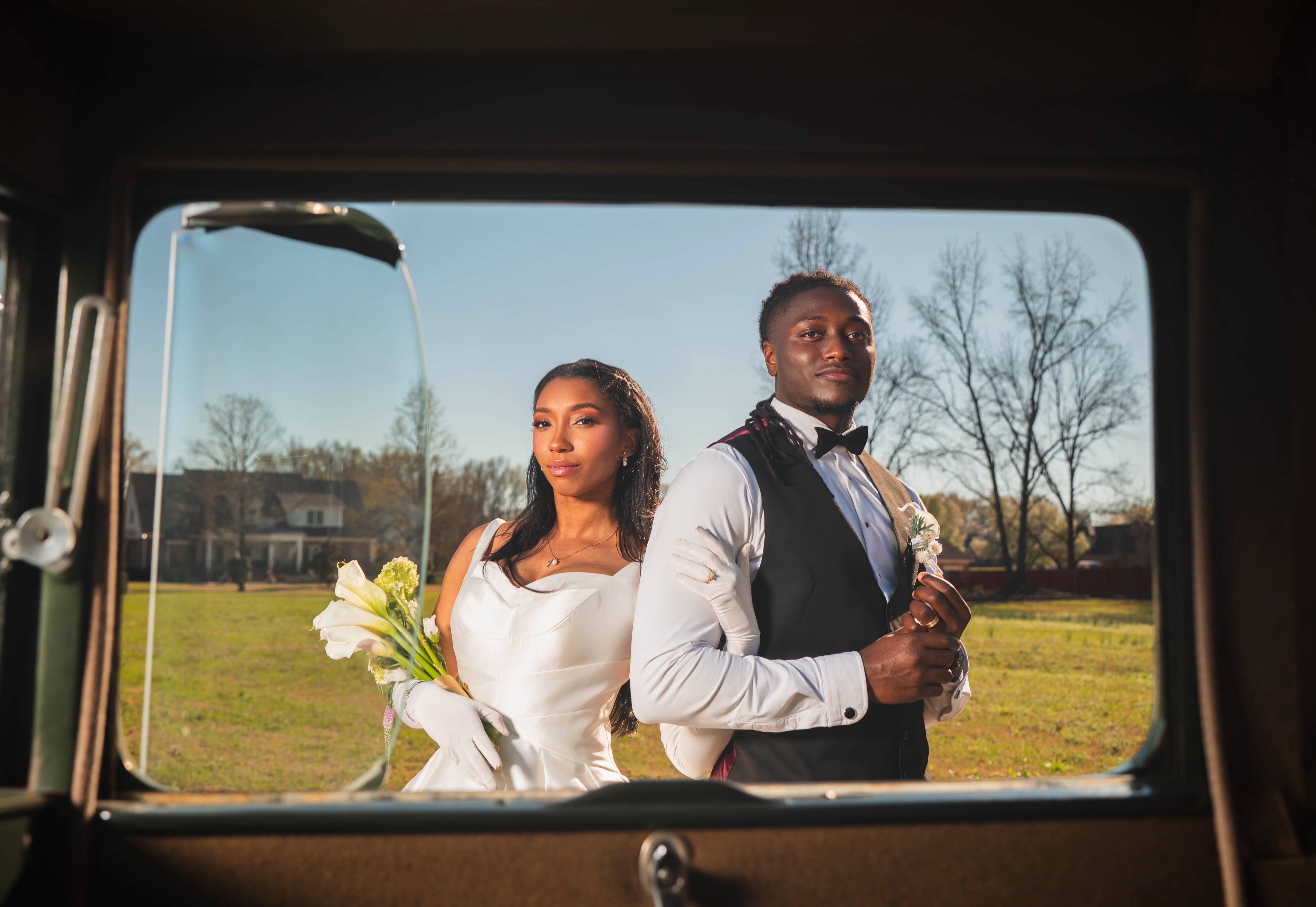 Couple in vintage car — candid window light through rear glass